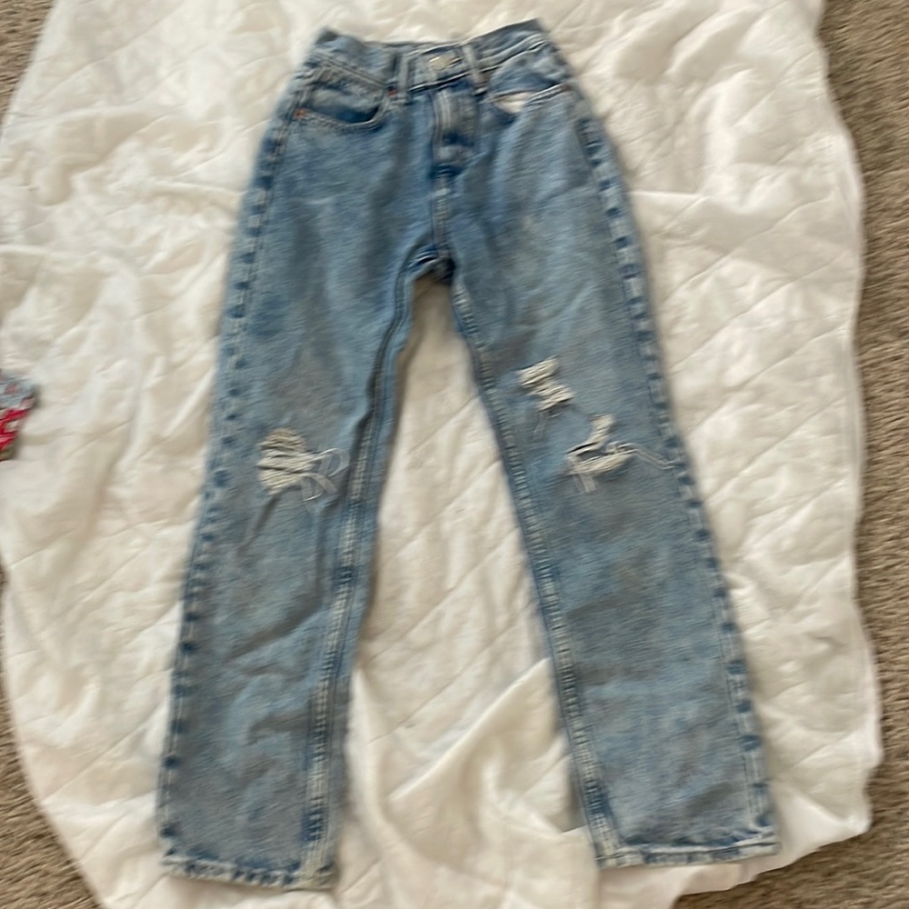 Girls size large blue jeans with multiple rips